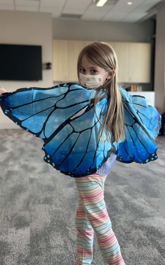 Image from Programs they love - Little girl showing her butterfly wings