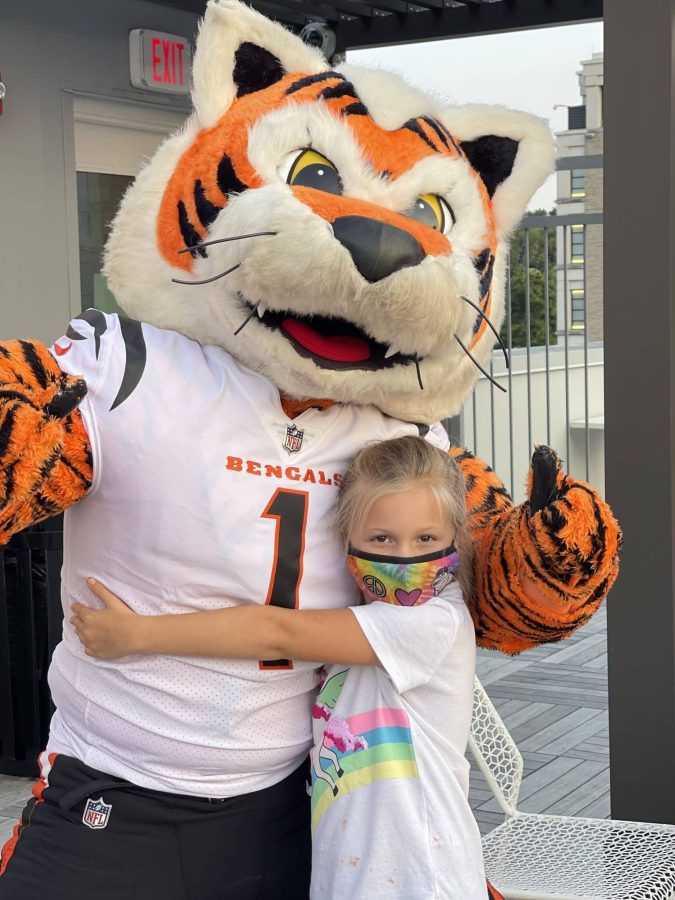 Image from Moments of Joy - Girl hugged a Bengals mascot