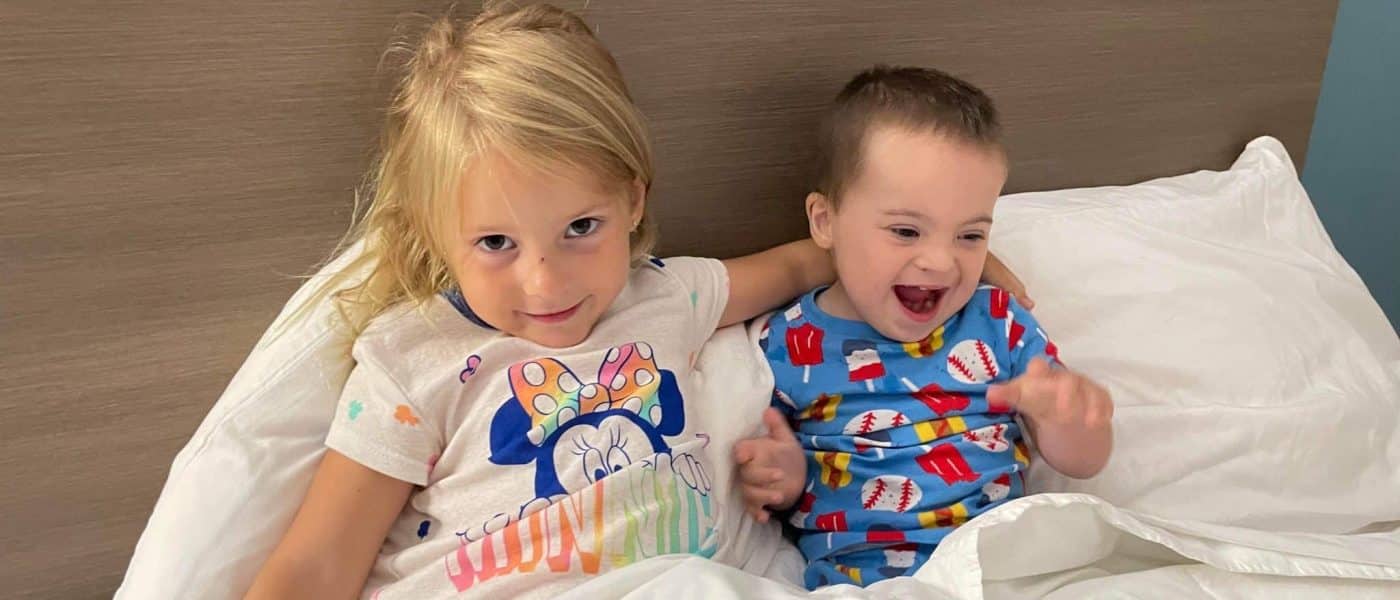 Two children sharing a hospital bed